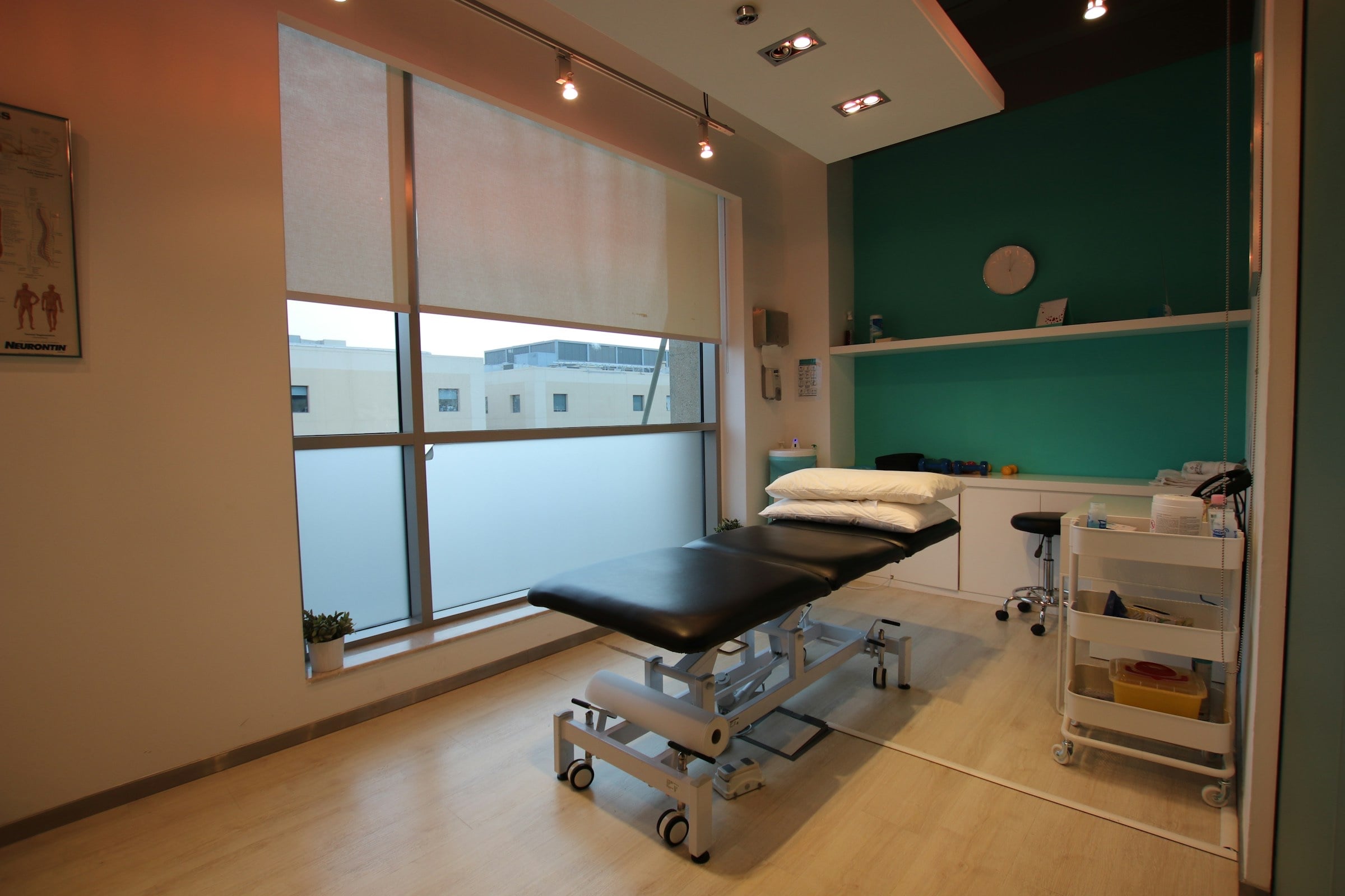 A treatment room with an adjustable table, ready for the next appointment